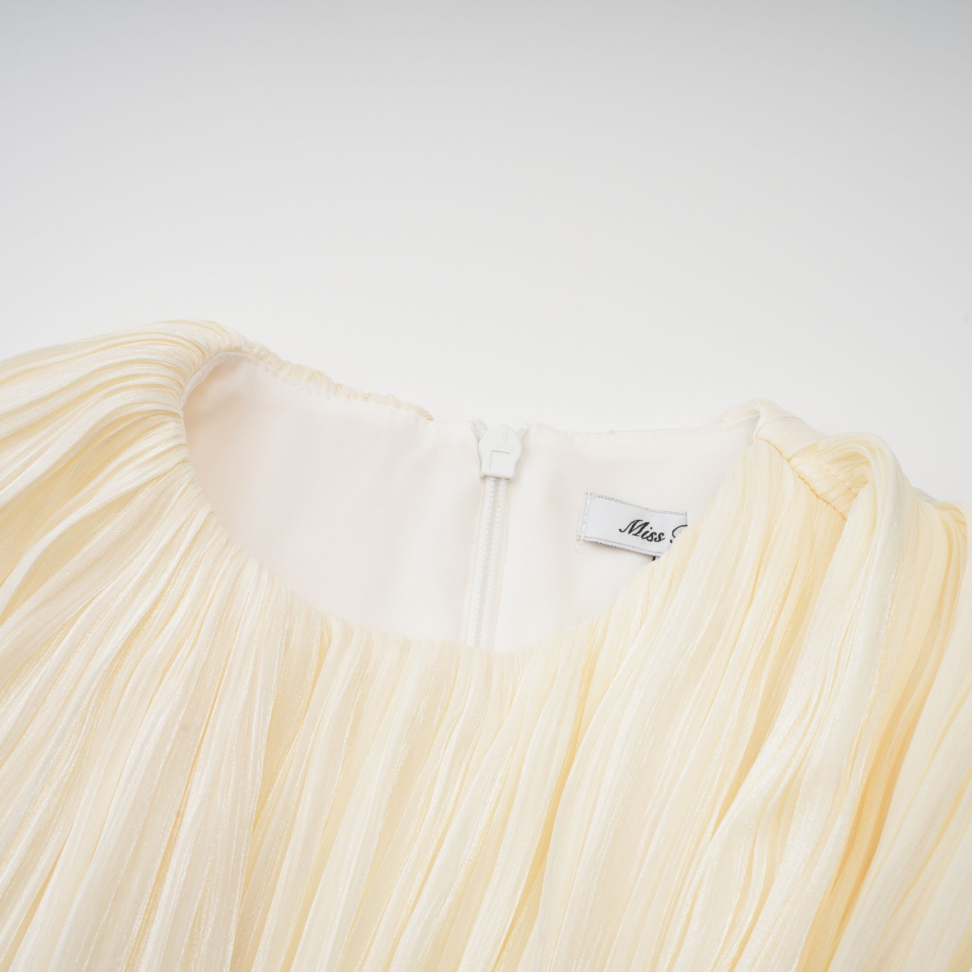 Cyrielle Pleated Mini Dress Round Neck Asymmetrical Ribbon Design Detail Neutrals