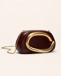 Vanya Sculptural Clutch Bag Rounded Shape Metallic Accent Chain Strap Brown